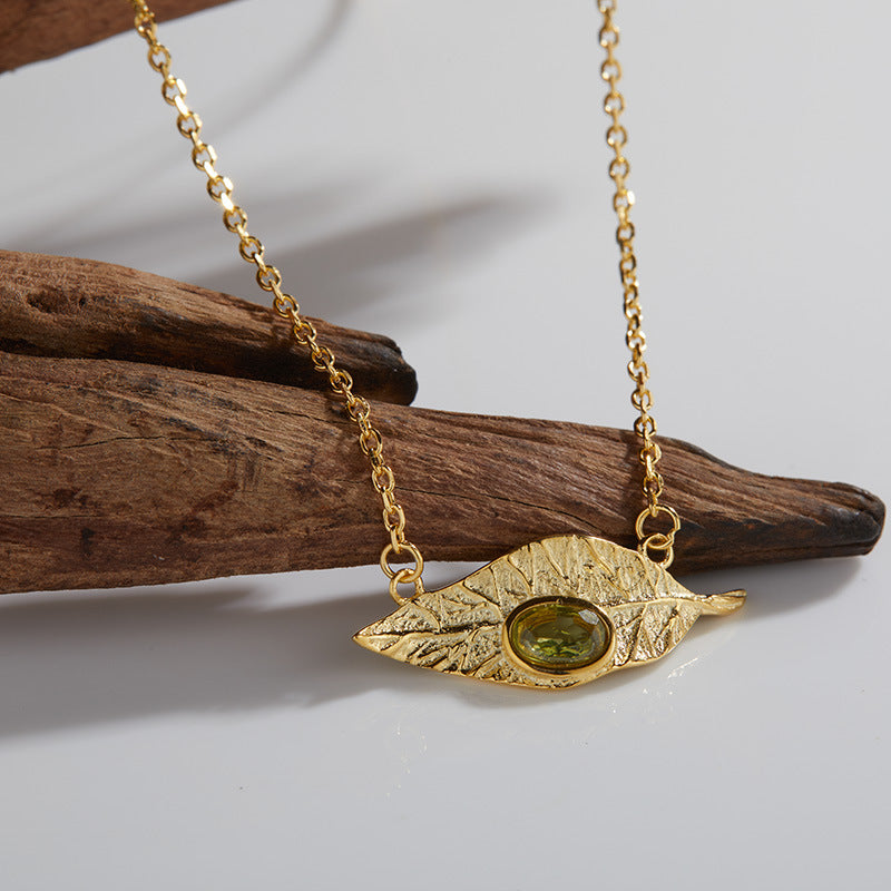 Conjunto de joyas de hojas: collar, anillo, pendientes y pulsera de granate, topacio azul y peridoto.