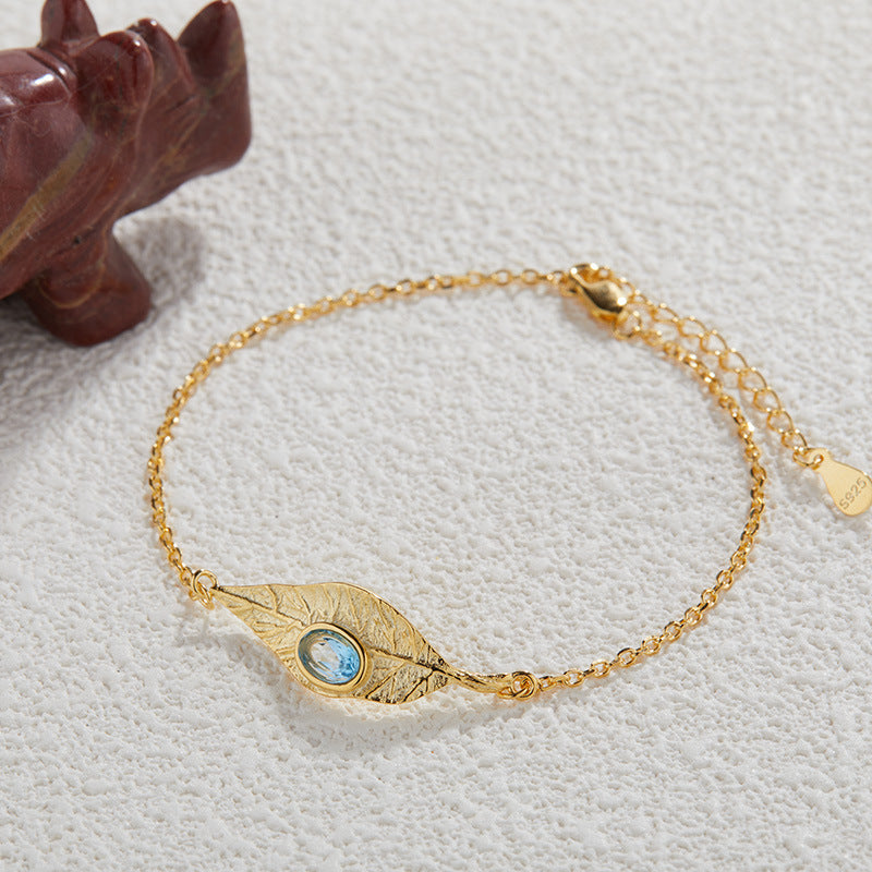 Conjunto de joyas de hojas: collar, anillo, pendientes y pulsera de granate, topacio azul y peridoto.